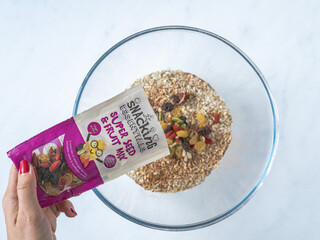 <p>In a large bowl mix oats with Snacking Essentials Super Seed and Fruit Mix, cinnamon, nutmeg, ginger, baking powder and salt.</p>