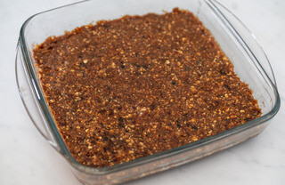 <p>Next drain the dates and add them to the mix together with pinch of salt and vanilla extract</p><p>Process until you get a sticky mixture.</p><p>Get a square baking dish, put the mixture in, press down and spread evenly. Pop into the fridge to set while you make the chocolate topping</p>